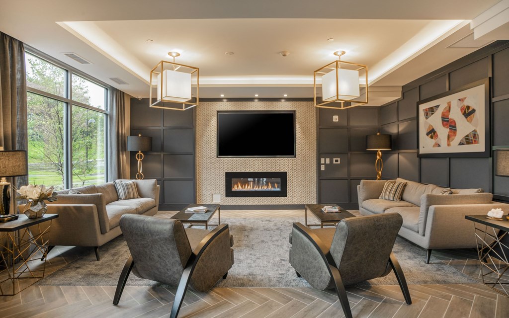 a living room with couches and chairs and a fireplace