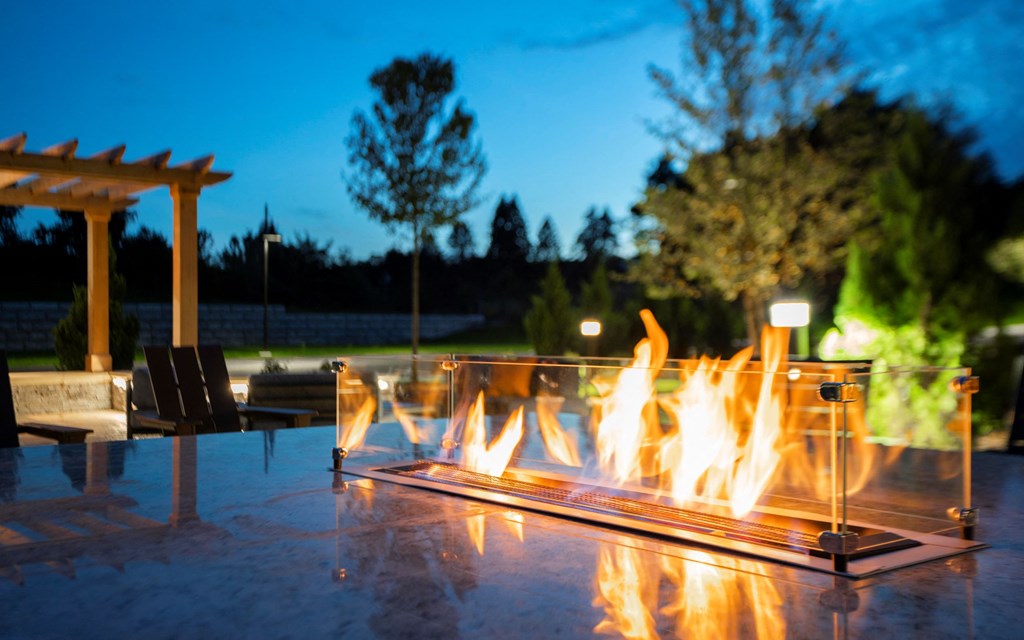 a fire pit in a garden at night