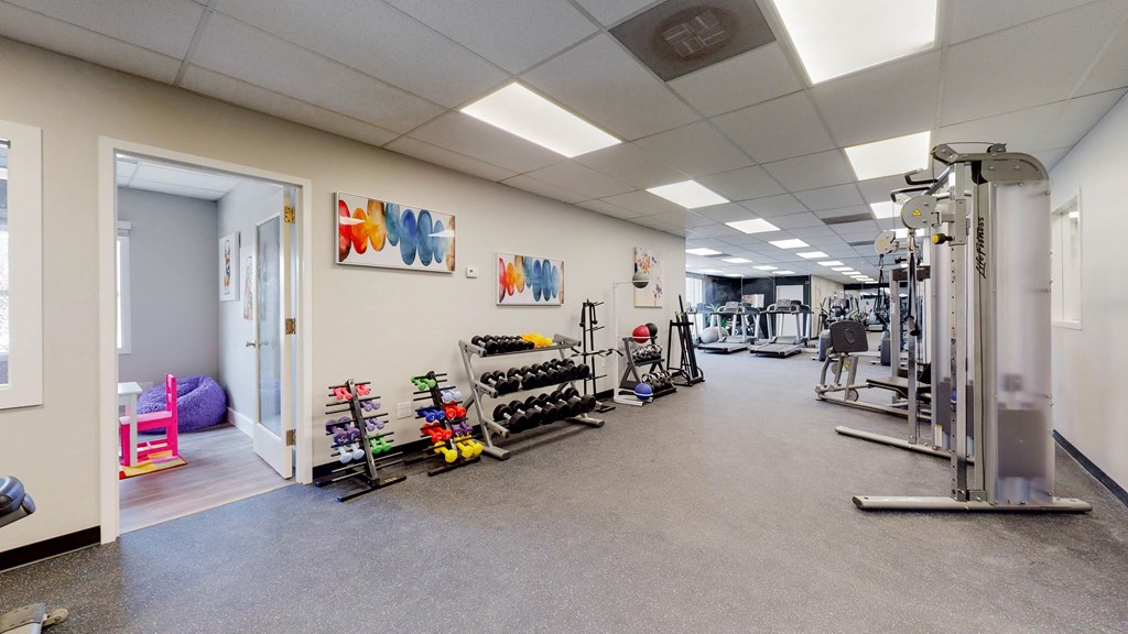 the gym with weights and cardio equipment at trillium apartments