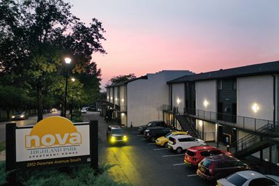 entrance sign in front of Nova Highland Park Apartments at Dusk
