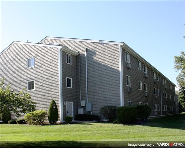 an apartment building with a shadow on the side of it