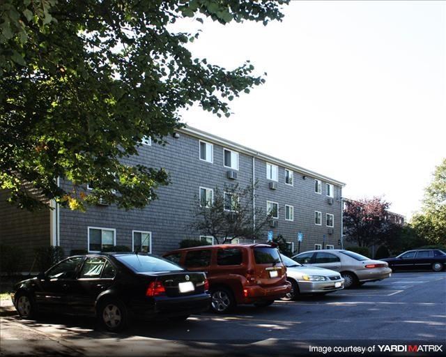 a parking lot with cars parked in front of a building