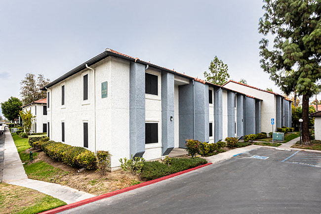 Exterior building view with sidewalk l Tides at Grand Terrace