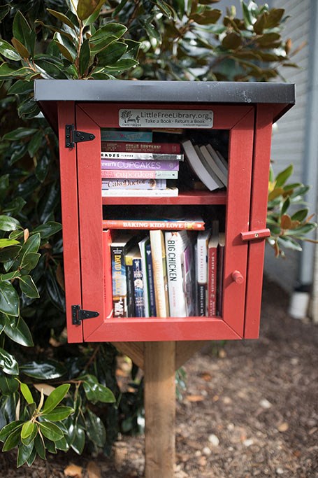 a red mailbox with books in it