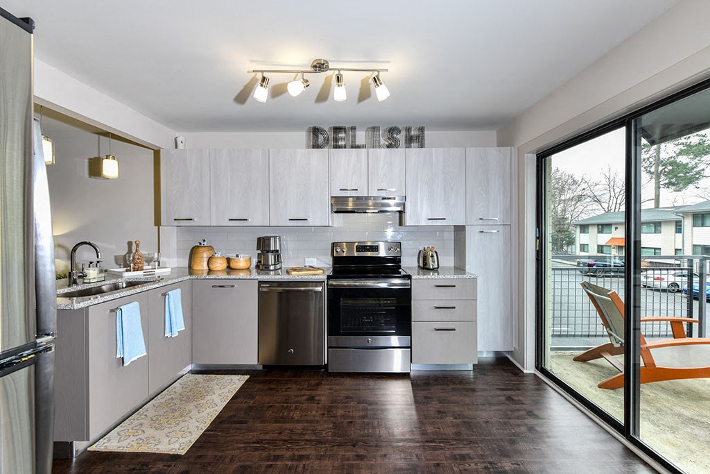 a kitchen with stainless steel appliances and a sliding glass door