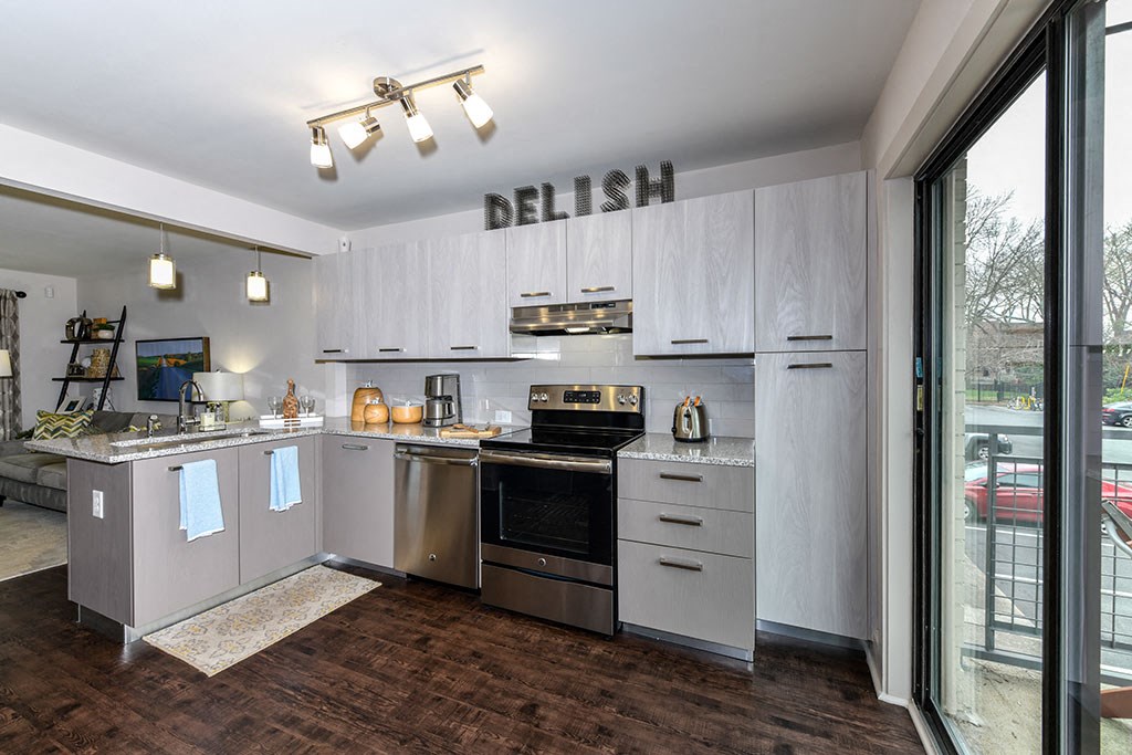 a kitchen with stainless steel appliances and white cabinets