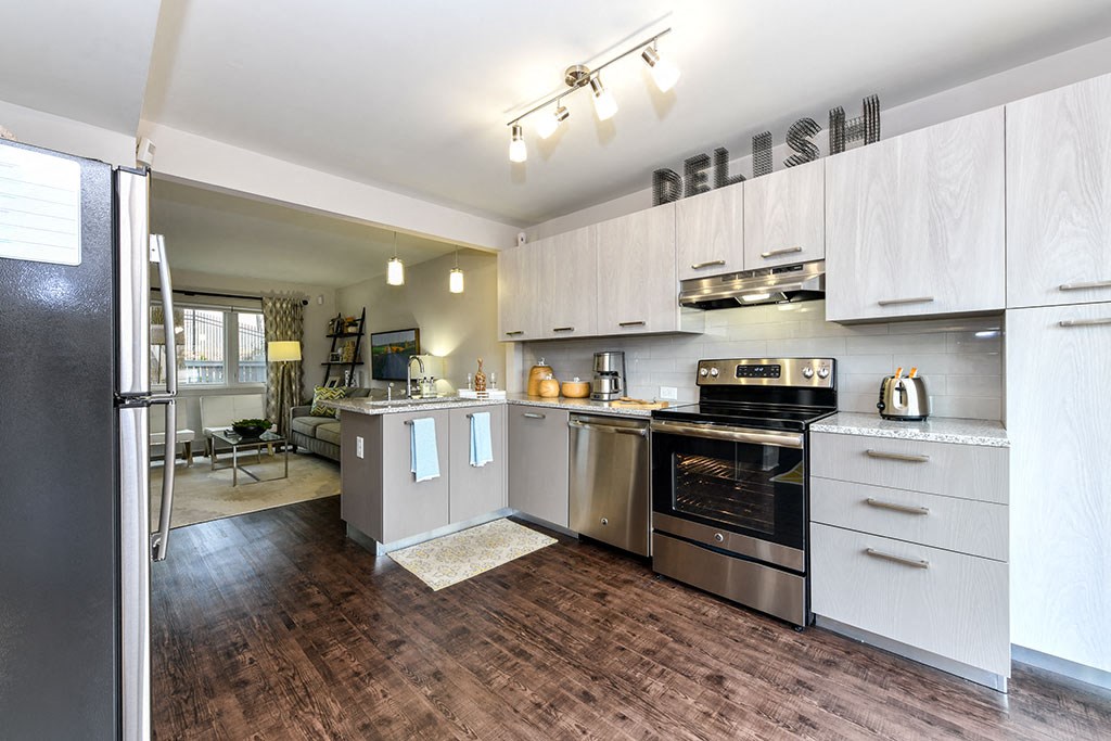 a kitchen with stainless steel appliances and white cabinets