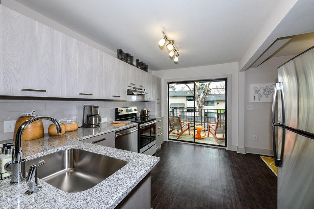 a kitchen with stainless steel appliances and granite counter tops