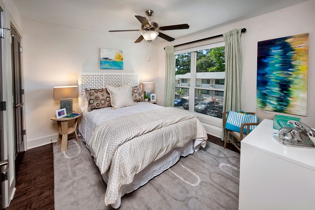 a bedroom with a bed and a ceiling fan