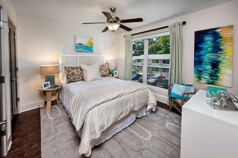 a bedroom with a bed and windows