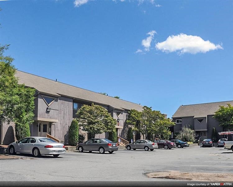 a parking lot with cars in front of a building