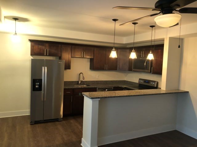a kitchen with a counter top and a refrigerator