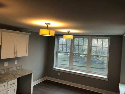 a kitchen with a large window and two ceiling lights