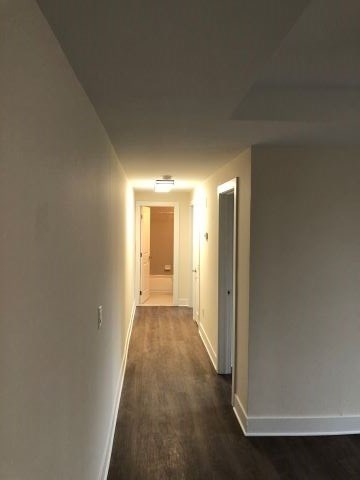 a hallway with a door to a bathroom and a hall way