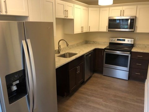 a kitchen with stainless steel appliances and white cabinets