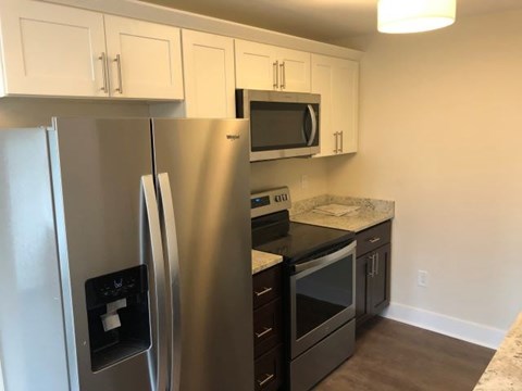 a kitchen with a stainless steel refrigerator and stove