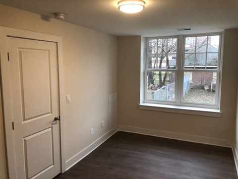 a empty room with a window and a door