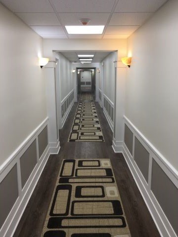 a long hallway with rugs on the floor