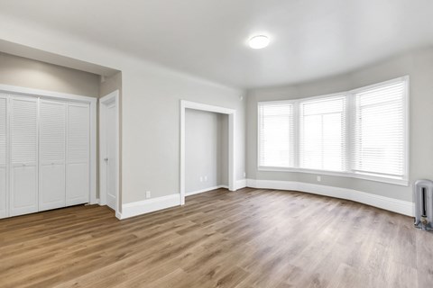A room with wooden floors and white walls.