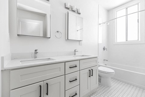 A white bathroom with a toilet and sink.