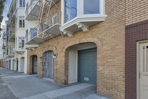 A row of buildings with a blue door in the middle.