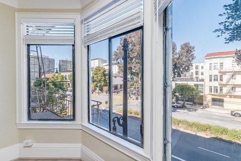 A view from a window looking out at a city street.
