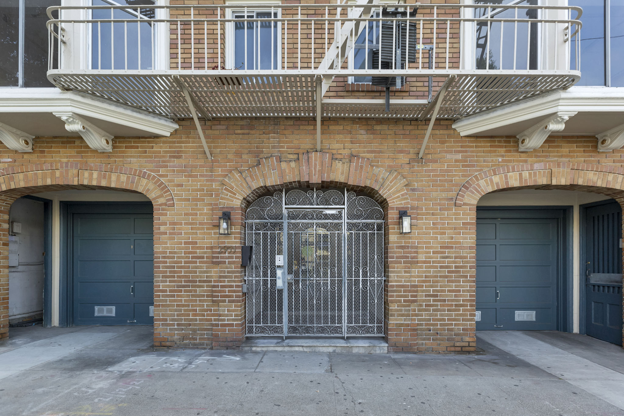 A brick building with a metal gate in the center.