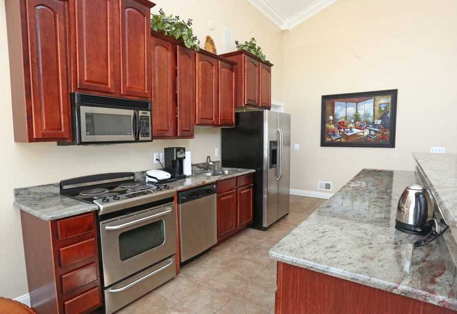 a kitchen with stainless steel appliances and wooden cabinets