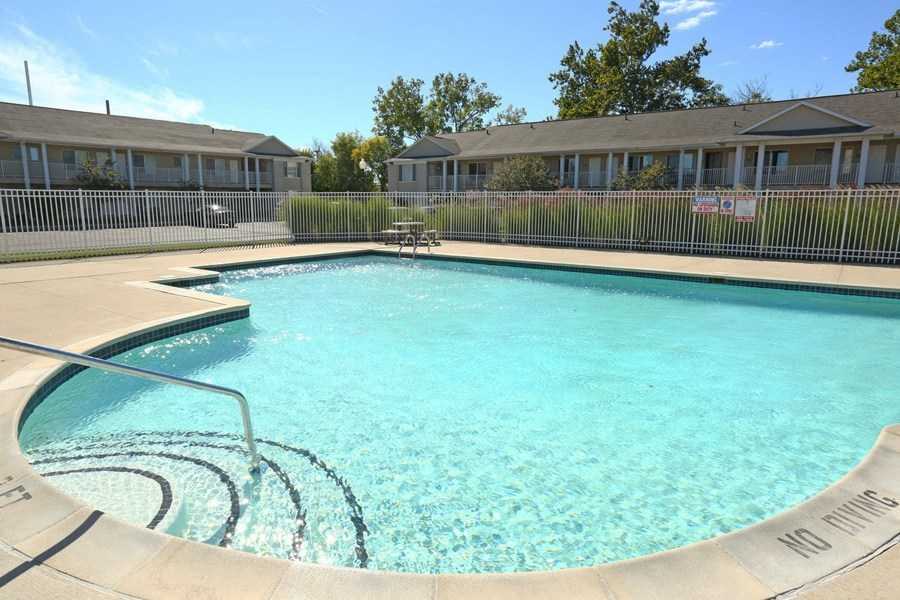 a large swimming pool in front of a house