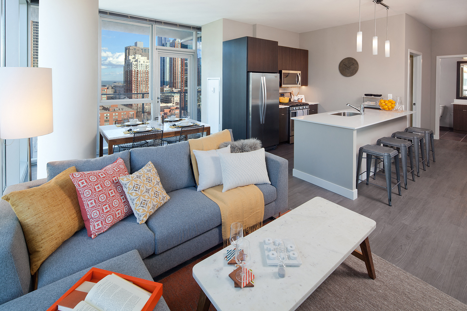 A modern living room with a grey couch and a coffee table.