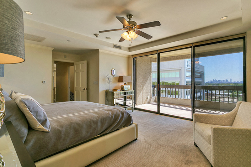 Stunning master bedroom with large patio, ceiling fan and carpet