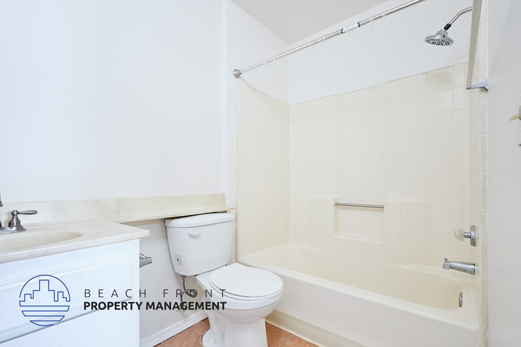 A white toilet is next to a sink in a bathroom.