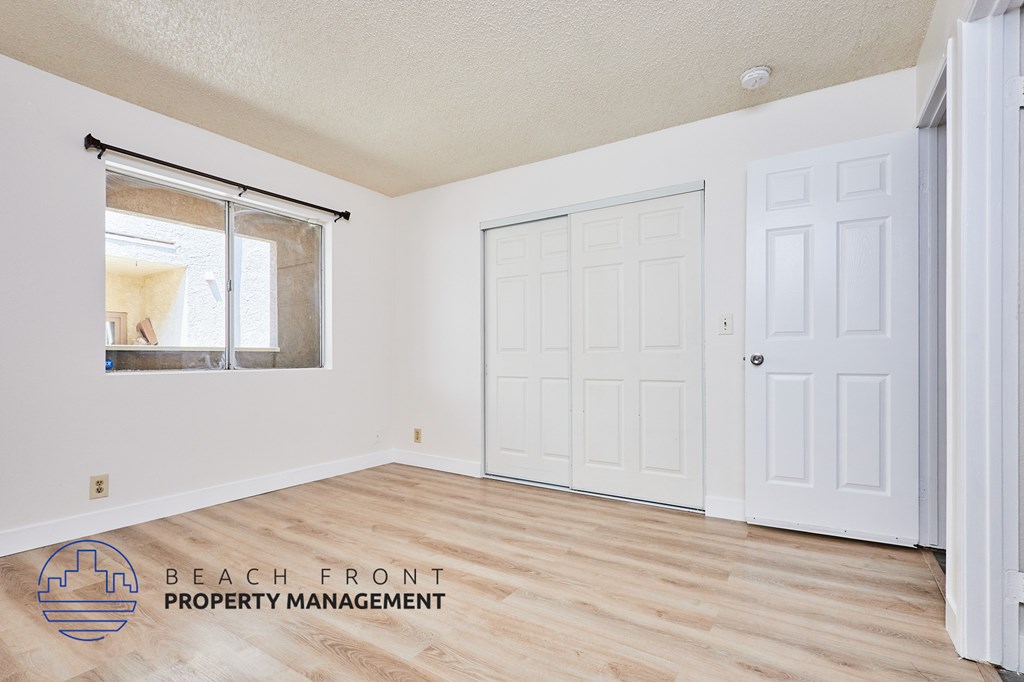 A room with a sliding glass door and a white door.