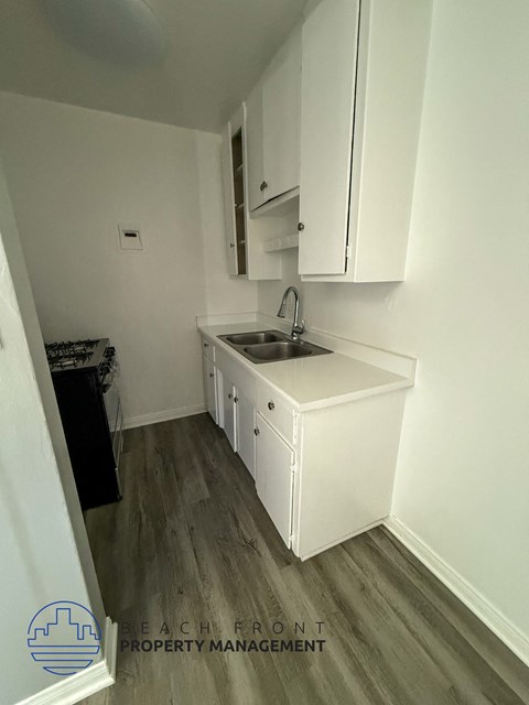 A small kitchen with a sink and cabinets.