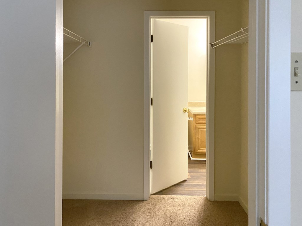 closet area with doorway to bathroom