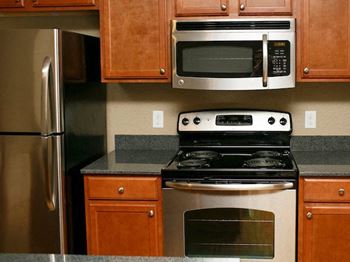 Stainless steel fridge, stove, and microwave at Fenwyck Manor Apartments, Chesapeake, VA