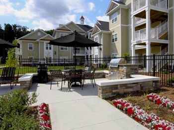 Outdoor grilling and picnic area with wide sidewalk at Fenwyck Manor Apartments, Chesapeake, 23320