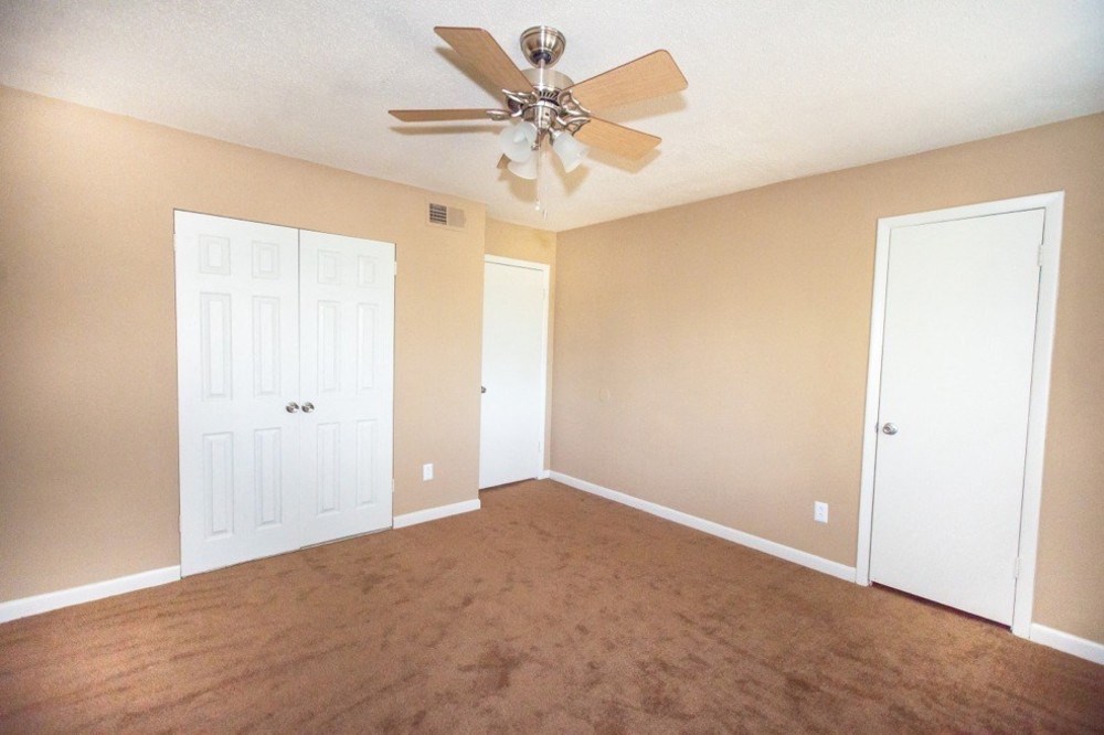 large bedroom with ceiling fan with lights