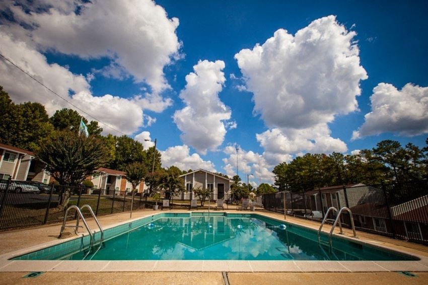 sparkling pool with puffy white clouds in blue sky - Photo Gallery 1