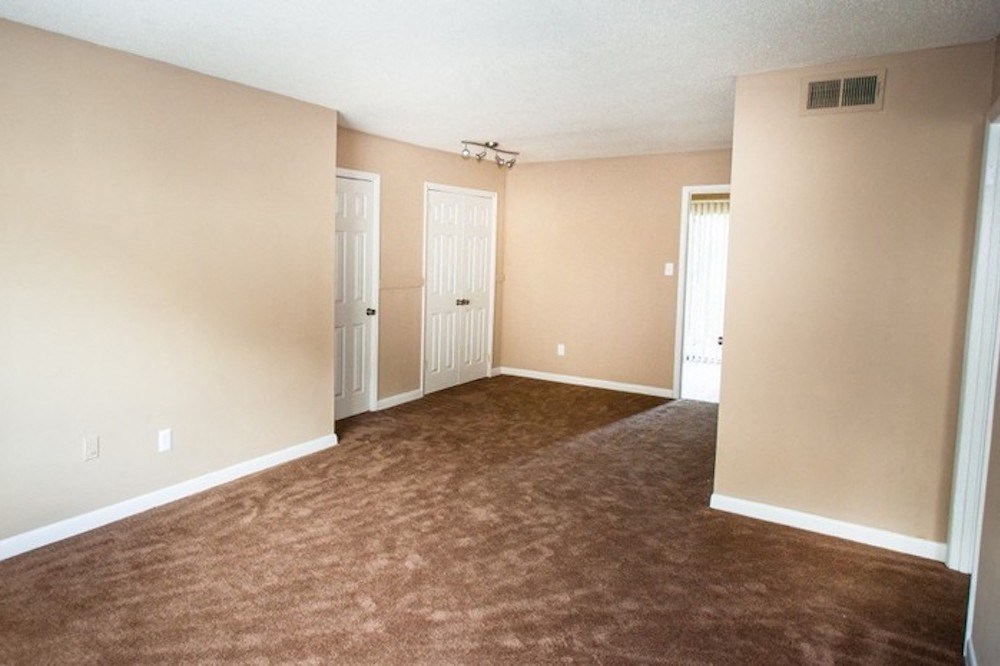 spacious living room with plush carpeting