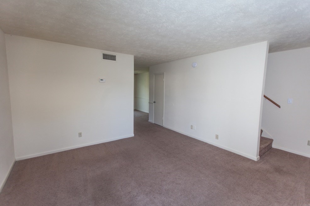 living room with stairwell leading upstairs
