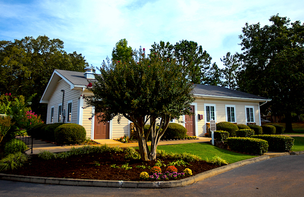 leasing office with flowers and lush, established landscaping