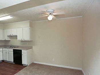 ceiling fan in living room area by kitchen