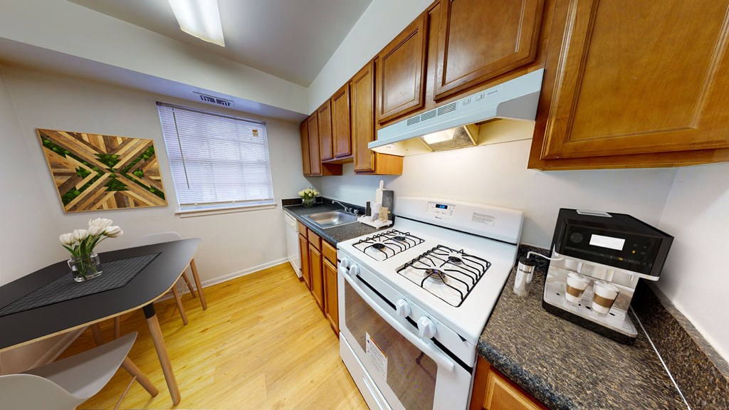 a kitchen with a stove top oven and a table