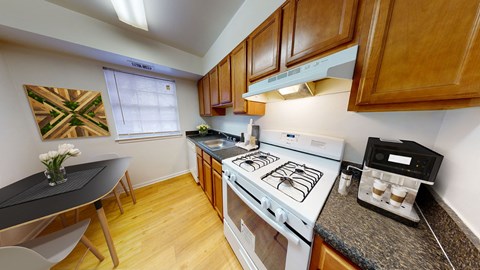 a kitchen with a stove top oven and a table