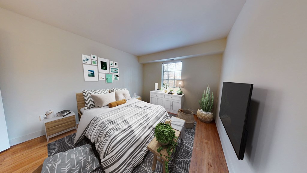 a bedroom with a bed and a tv