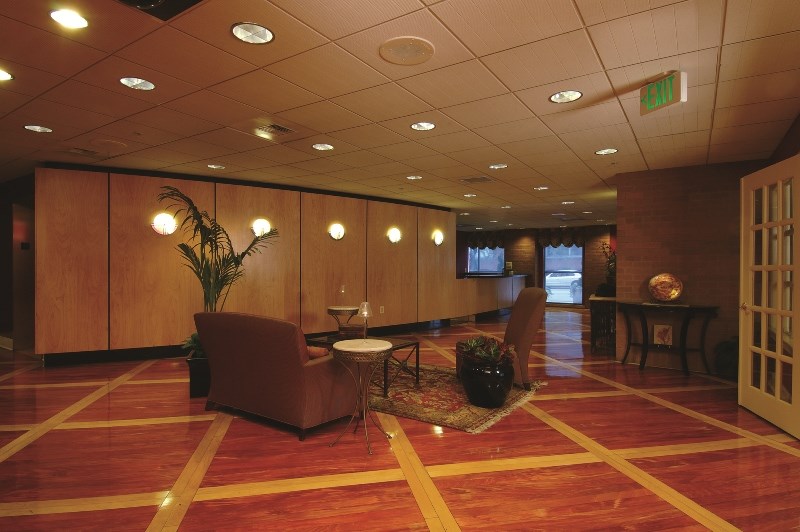 a large room with chairs and a table in a lobby