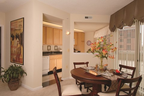 a dining room and kitchen with a table and chairs