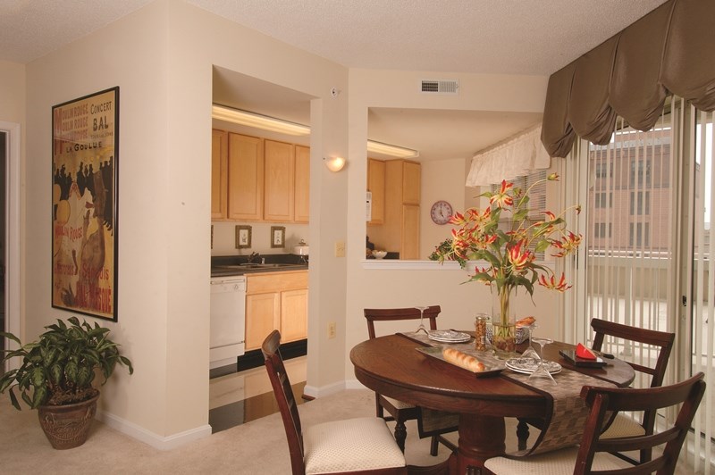 a dining room and kitchen with a table and chairs