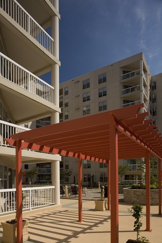 a red pergola in front of an apartment building